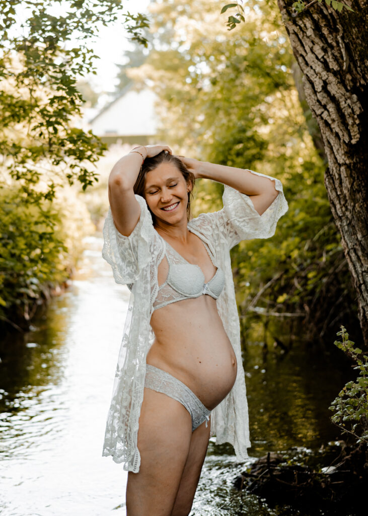 Portrait d'une femme enceinte dans l'eau lors d'une séance photo grossesse intimiste en auvergne